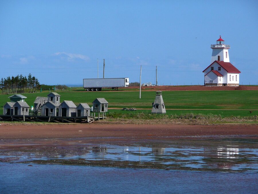 Old fishing huts and lighthouse on the Prince Edward Island shoreline