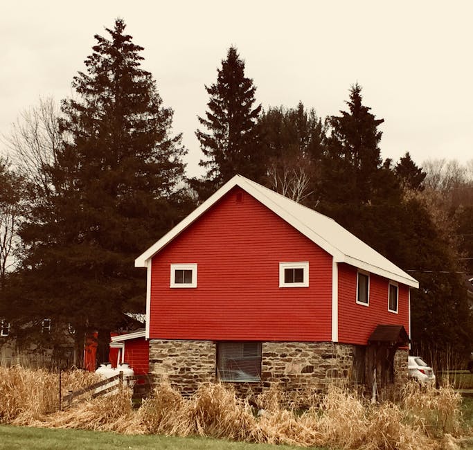 Red barn with stone foundation in rural countryside