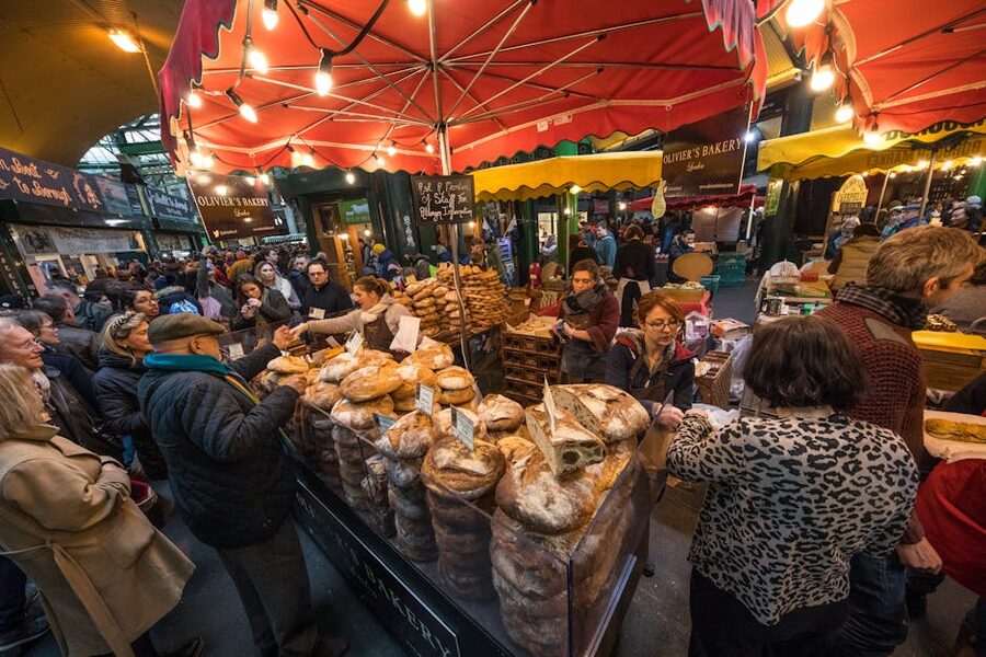 Crowds and food stalls at Borough Market in London on a busy weekday lunchtime