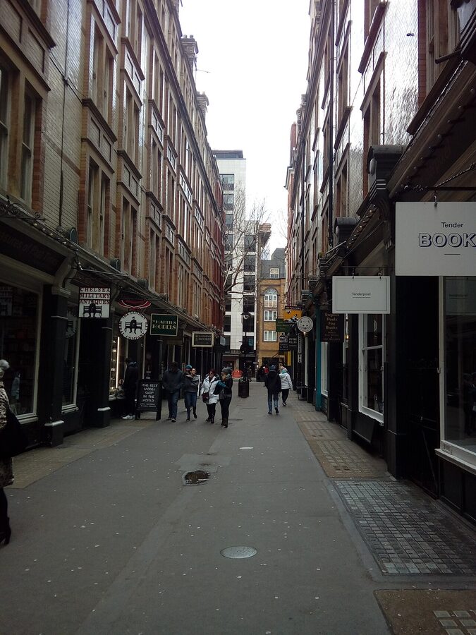 Cecil Court in London with rows of independent bookshops and Victorian shopfronts