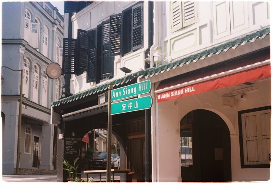 A row of restored colourful shophouses on Ann Siang Road in Singapore Chinatown with bars and restaurants at street level