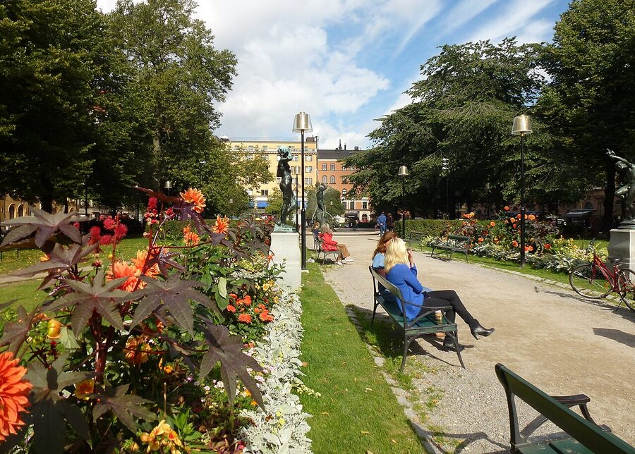 The leafy Mariatorget square in Söder Stockholm with a fountain and benches