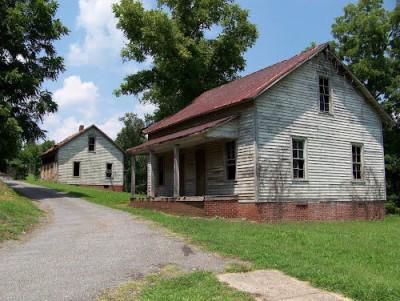 Row of weathered worker cottages at Henry River Mill Village in North Carolina