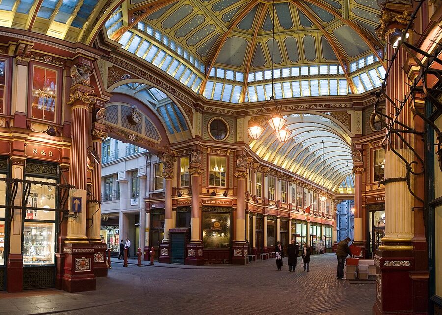 Wide view of Leadenhall Market's Victorian glass and iron roof above cobbled passages