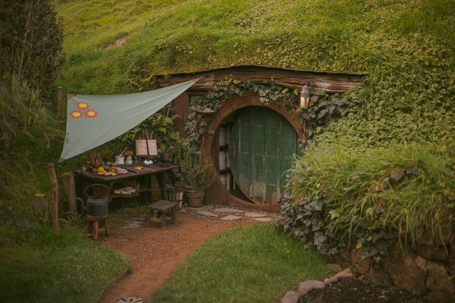Hobbit hole cottage tucked into a hillside garden at Hobbiton