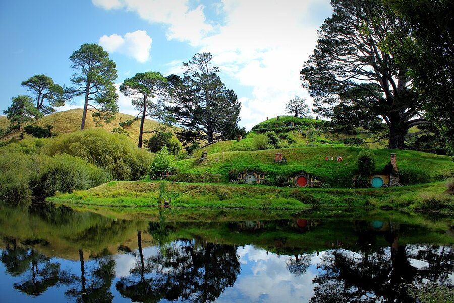 Hobbit holes mirrored in the lake at Hobbiton