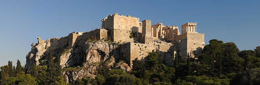 View of the Acropolis from the slick rocks of Areopagus Hill in Athens at golden hour