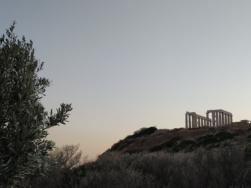 The Temple of Poseidon at Cape Sounion glowing in the late afternoon sun above the Aegean Sea
