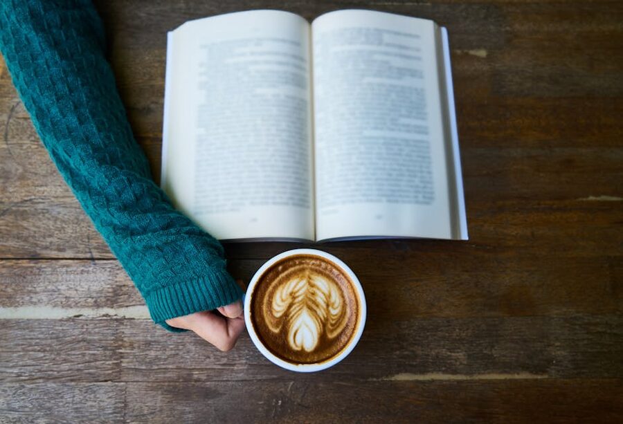 A cosy cafe scene with an open paperback and a flat white, the kind of stop you make mid-trip