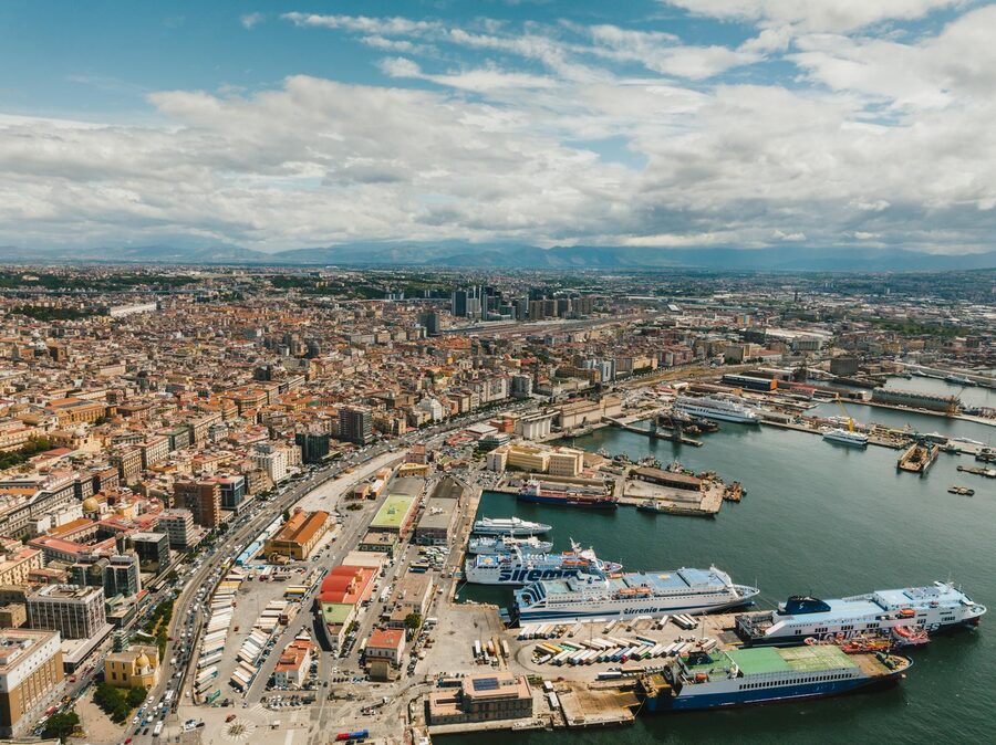 Aerial view over the Bay of Naples showing the harbour and city below the volcano of Vesuvius in the distance
